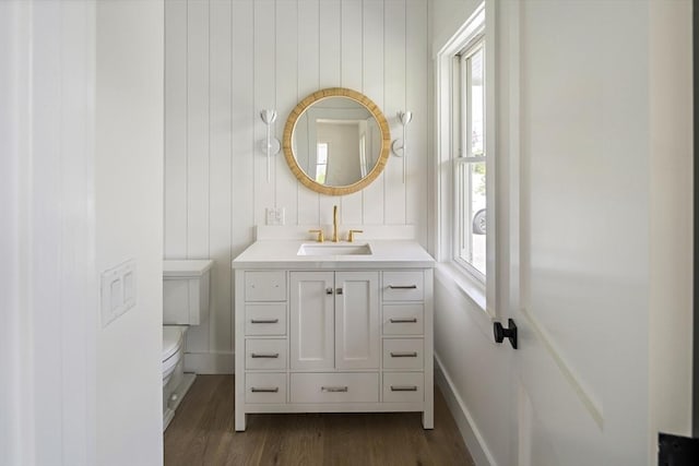 30 Franklin Ave, Oak Bluffs, MA 02557 - half bathroom featuring toilet, wood finished floors, vanity, and baseboards