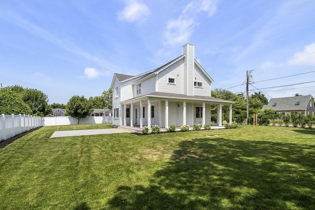 30 Franklin Ave, Oak Bluffs, MA 02557 - rear view of property with a chimney and covered porch