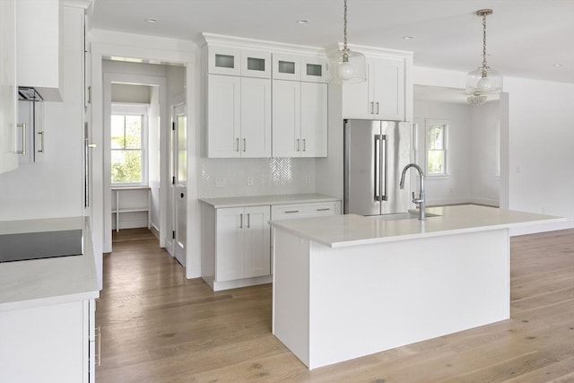 30 Franklin Ave, Oak Bluffs, MA 02557 - kitchen with high end fridge, a sink, black electric stovetop, light wood-type flooring, and recessed lighting