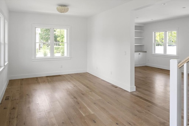 30 Franklin Ave, Oak Bluffs, MA 02557 - spare room with light wood finished floors, baseboards, built in shelves, and stairs