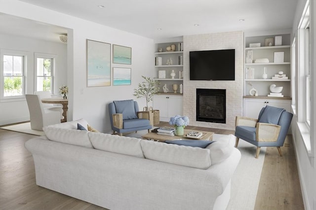 30 Franklin Ave, Oak Bluffs, MA 02557 - living room featuring wood finished floors, built in features, and a brick fireplace