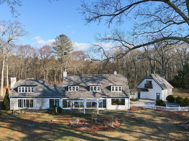 rear view of house featuring a lawn