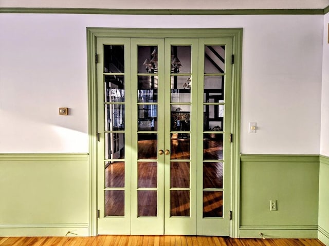 entryway with french doors and light hardwood / wood-style flooring