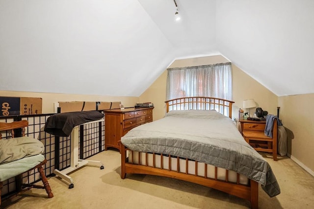 bedroom with lofted ceiling and light carpet