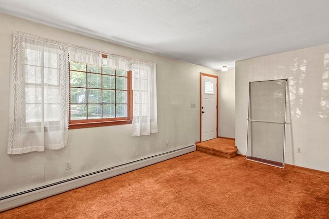 carpeted spare room with a baseboard radiator and a textured ceiling