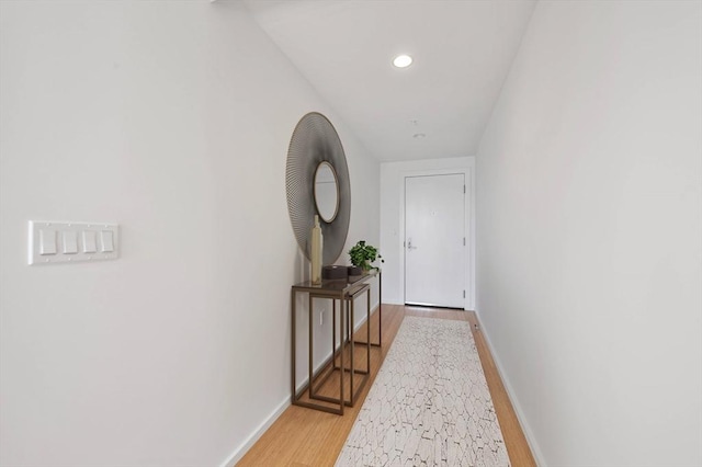 hallway with baseboards, recessed lighting, and wood finished floors
