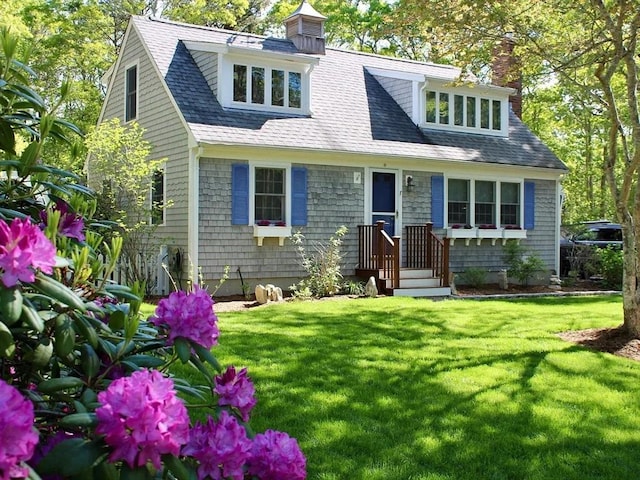 new england style home with a front lawn