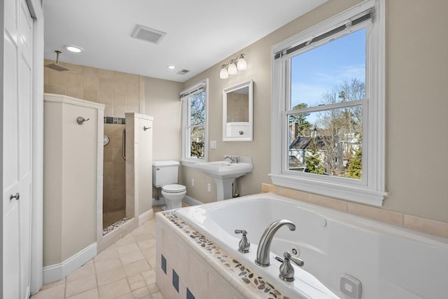 bathroom featuring a wealth of natural light, tile patterned floors, toilet, and separate shower and tub