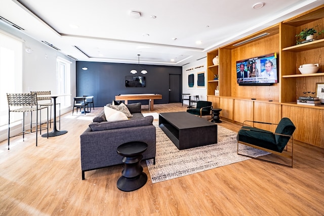 living room with light hardwood / wood-style floors and pool table