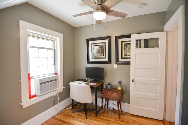 office space with cooling unit, ceiling fan, and light hardwood / wood-style flooring