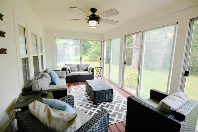 sunroom with a healthy amount of sunlight and ceiling fan