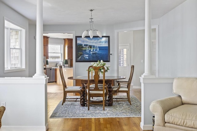 267 Barnes Rd, Oak Bluffs, MA 02557 - dining space featuring ornate columns and light wood finished floors