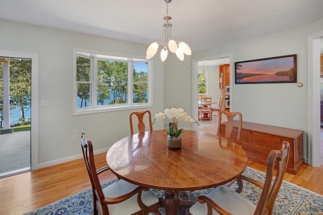 267 Barnes Rd, Oak Bluffs, MA 02557 - dining room featuring light wood finished floors, baseboards, and an inviting chandelier