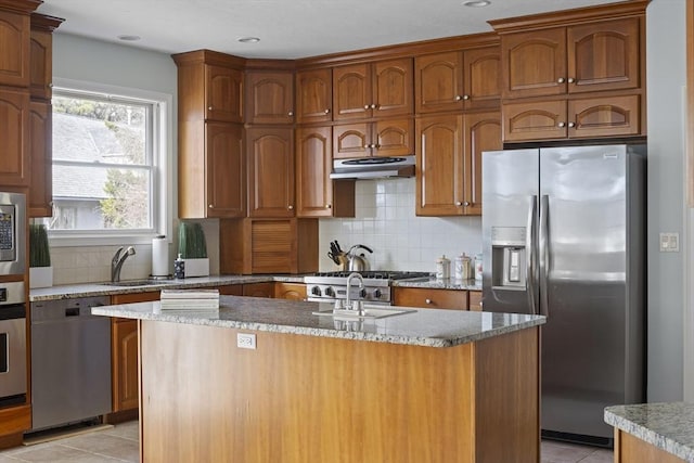 267 Barnes Rd, Oak Bluffs, MA 02557 - kitchen featuring light tile patterned flooring, backsplash, a sink, under cabinet range hood, and stainless steel appliances