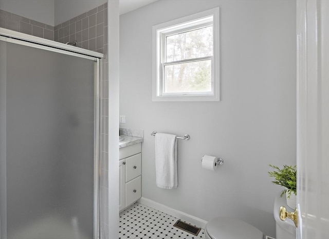 267 Barnes Rd, Oak Bluffs, MA 02557 - bathroom with vanity, toilet, baseboards, a shower stall, and visible vents