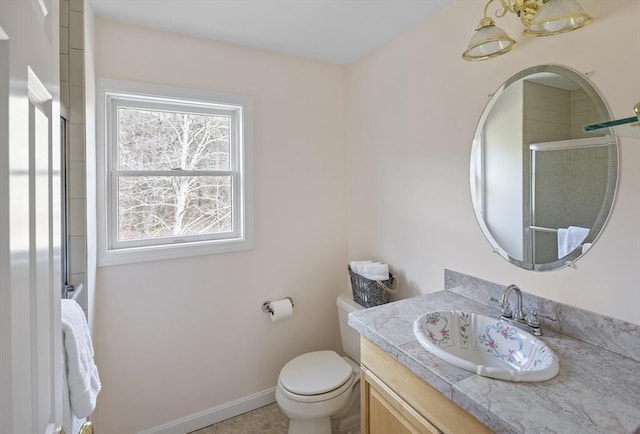 267 Barnes Rd, Oak Bluffs, MA 02557 - full bathroom with a shower with door, baseboards, toilet, and vanity