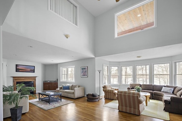 267 Barnes Rd, Oak Bluffs, MA 02557 - living area featuring a fireplace, wood finished floors, a towering ceiling, and a ceiling fan