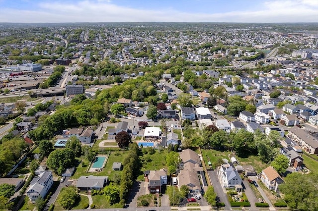 aerial view of property and surrounding area featuring nearby suburban area