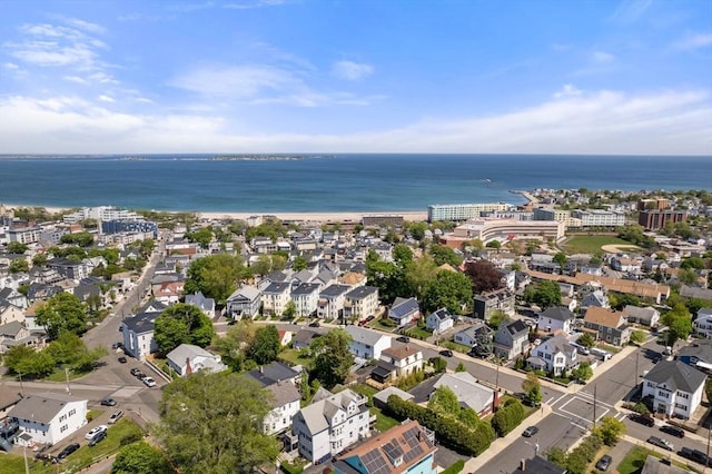 view of property location featuring a nearby body of water and nearby suburban area