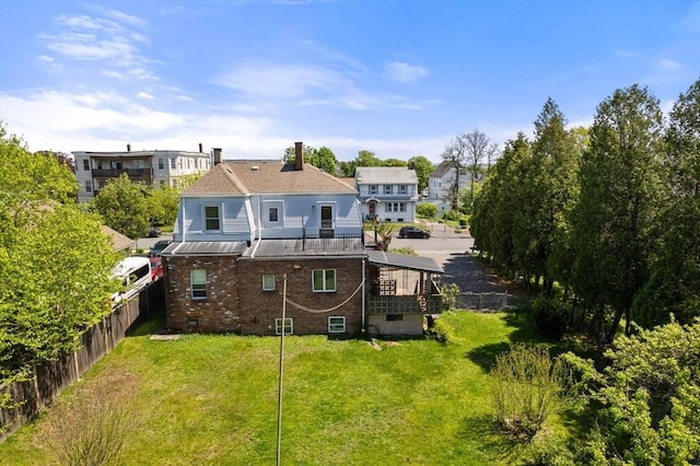 rear view of property featuring stairway, brick siding, and a chimney