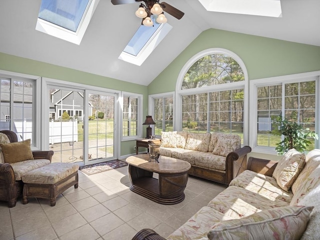 sunroom / solarium with a skylight, tile patterned floors, and high vaulted ceiling