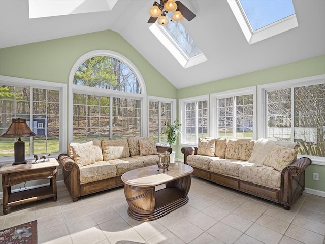 sunroom with tile patterned flooring, a skylight, and high vaulted ceiling