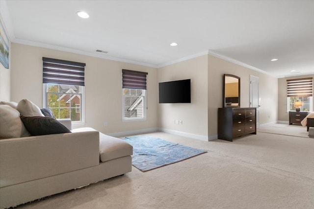 carpeted living area featuring baseboards, a wealth of natural light, ornamental molding, and visible vents