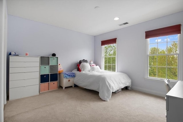 bedroom with light carpet and visible vents