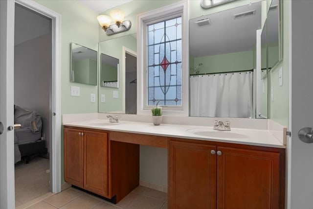 bathroom with tile patterned floors, visible vents, and a sink