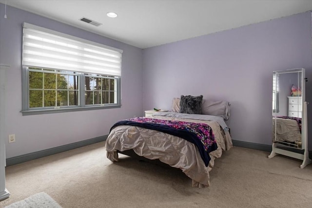 bedroom with baseboards, multiple windows, and carpet flooring