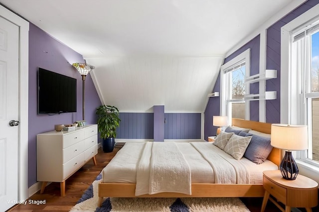 bedroom with lofted ceiling and dark hardwood / wood-style floors