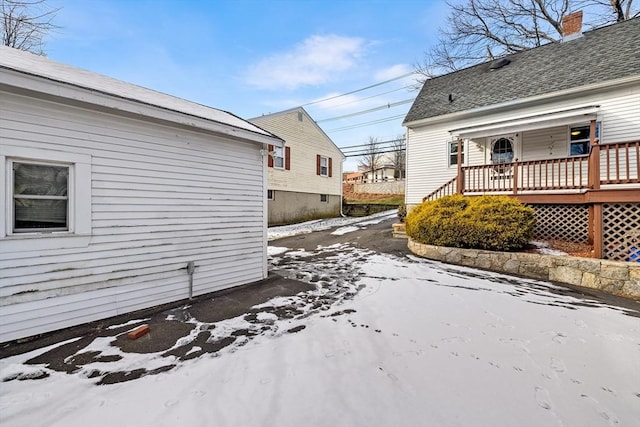 snow covered property with a deck