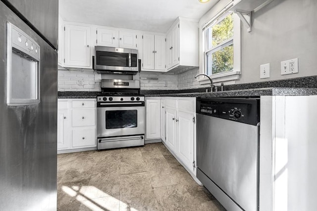 kitchen with backsplash, sink, white cabinetry, and appliances with stainless steel finishes