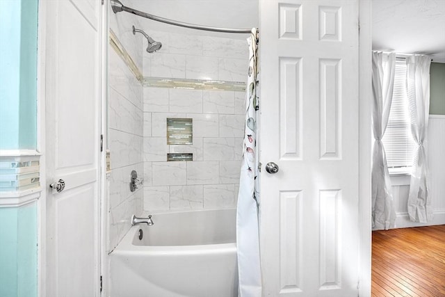 bathroom with shower / bath combo with shower curtain and hardwood / wood-style floors