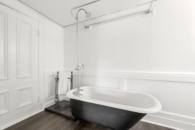 bathroom with hardwood / wood-style floors and a washtub