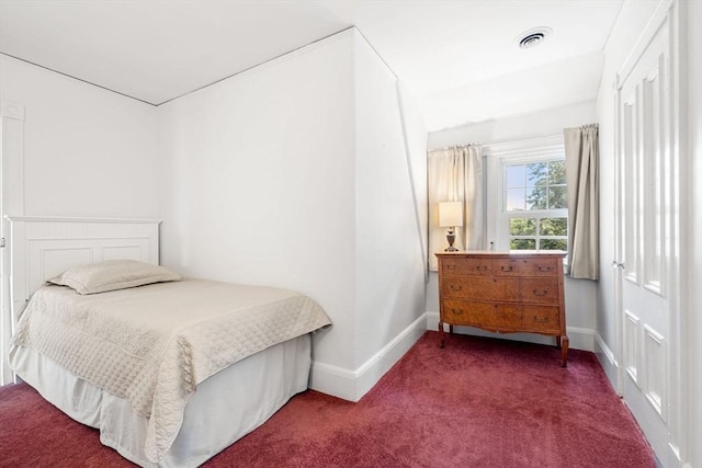 bedroom featuring dark colored carpet