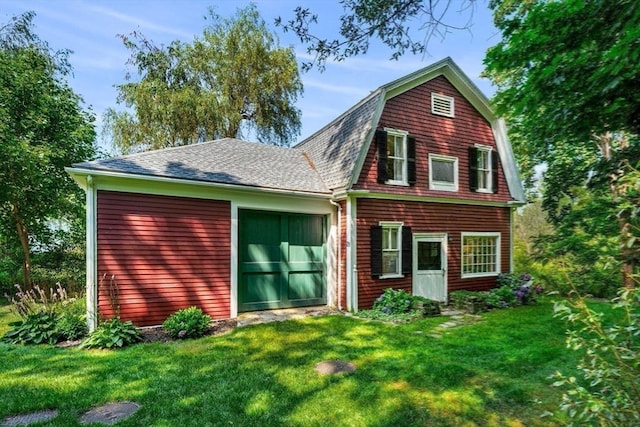 rear view of property featuring a yard