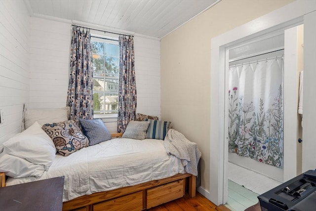 bedroom featuring hardwood / wood-style flooring and wooden ceiling