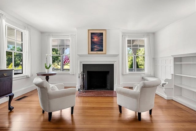 living area featuring a healthy amount of sunlight and light hardwood / wood-style floors