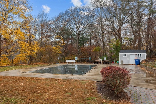 view of pool with an outbuilding and a patio area