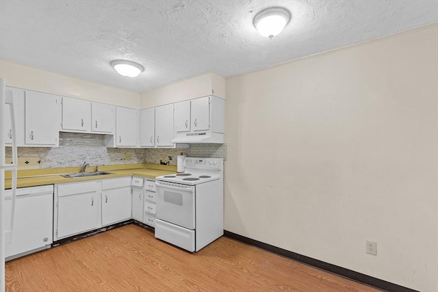 kitchen featuring sink, light wood-type flooring, backsplash, white cabinets, and white appliances