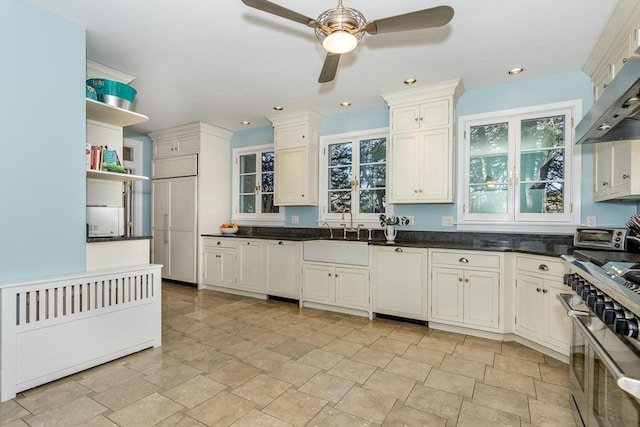 kitchen with open shelves, a sink, a ceiling fan, double oven range, and under cabinet range hood