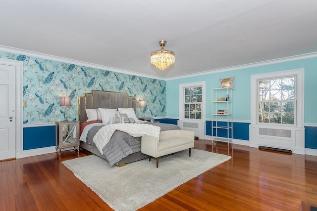 bedroom with ornamental molding, wood finished floors, radiator heating unit, wallpapered walls, and a notable chandelier