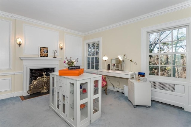 home office with a fireplace with flush hearth, light colored carpet, and ornamental molding