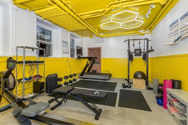 exercise area featuring a wainscoted wall