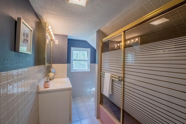 2 Fay Ct, Southborough, MA 01772 - full bathroom featuring tile walls, vanity, toilet, a shower with door, and vaulted ceiling