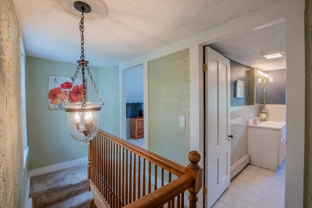 2 Fay Ct, Southborough, MA 01772 - hallway with a baseboard radiator, light flooring, a textured wall, and a textured ceiling