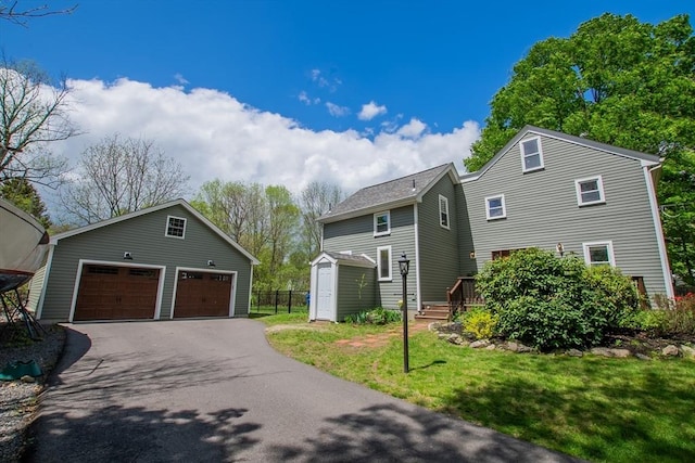2 Fay Ct, Southborough, MA 01772 - view of side of property with an outbuilding, a garage, and a storage shed