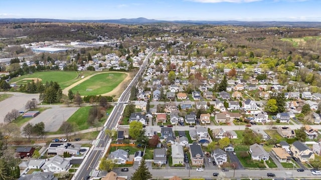 aerial overview of property's location with nearby suburban area and a mountainous background