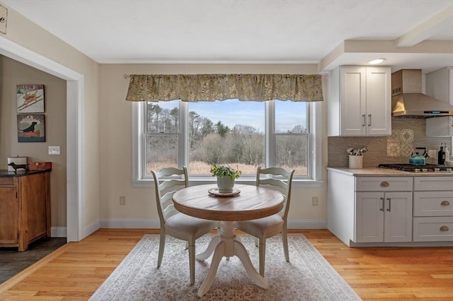 dining room with light wood-type flooring and baseboards